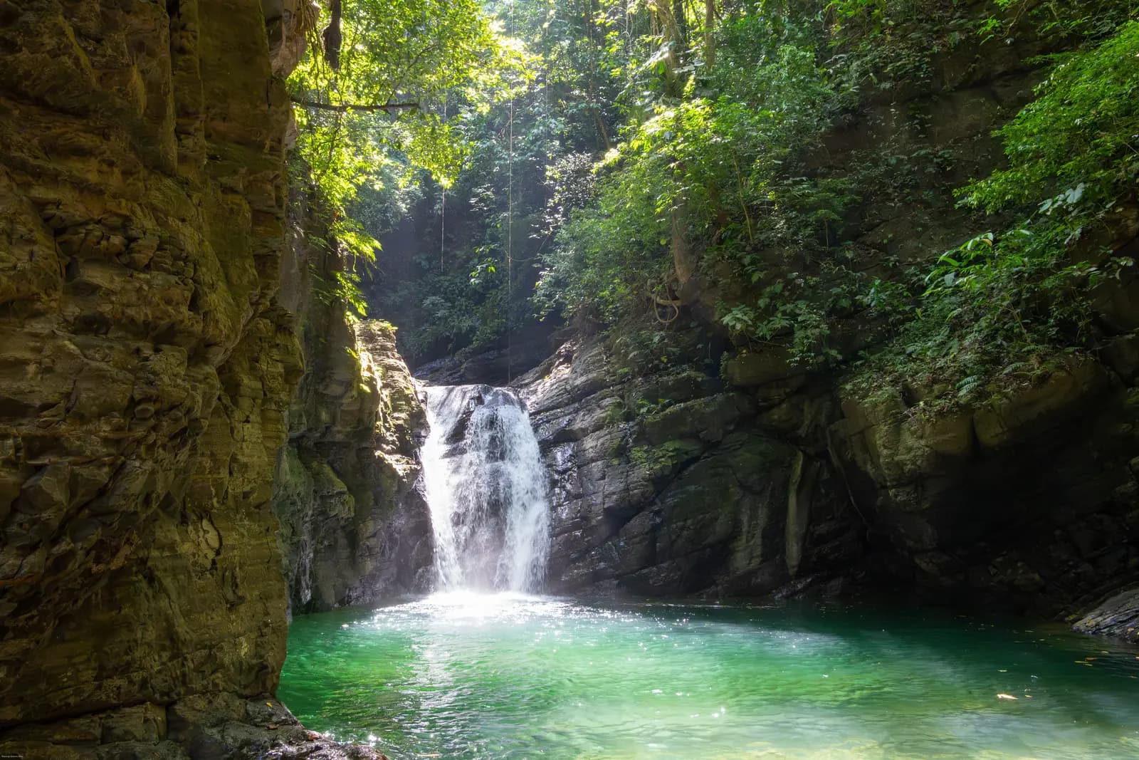 A waterfall dropping through a stone gorge